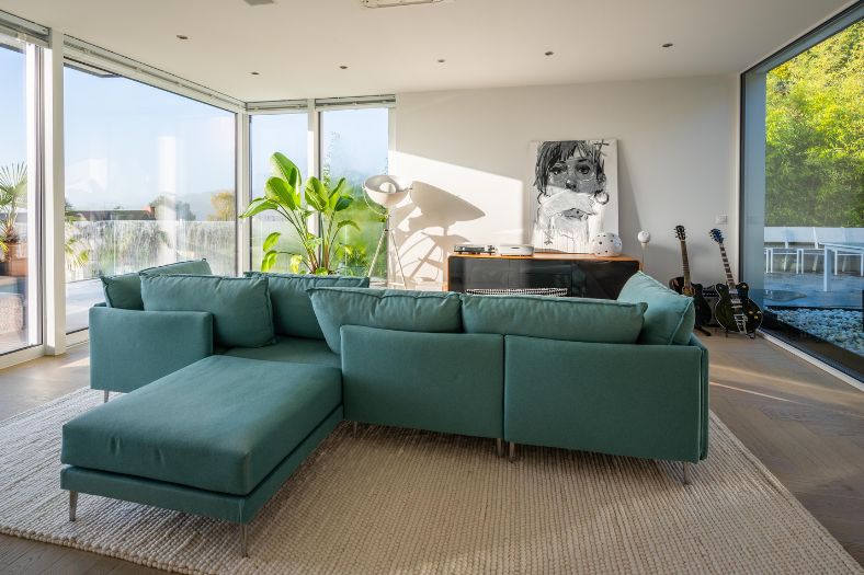 magnolia walls with green colour in living room