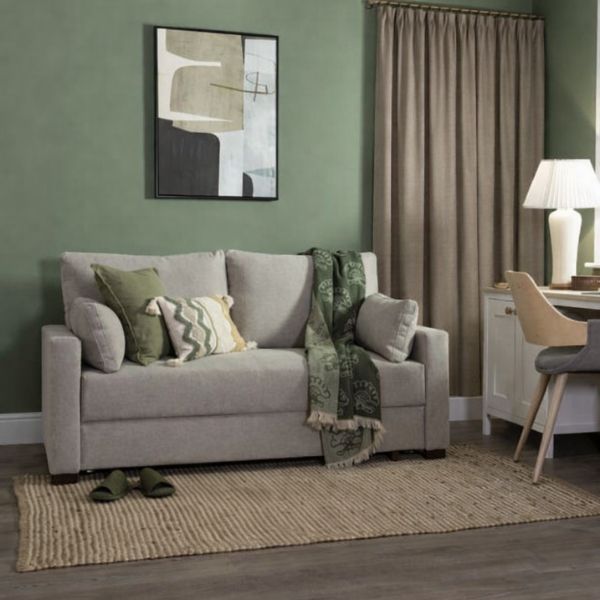 green walls with taupe curtains and grey sofa